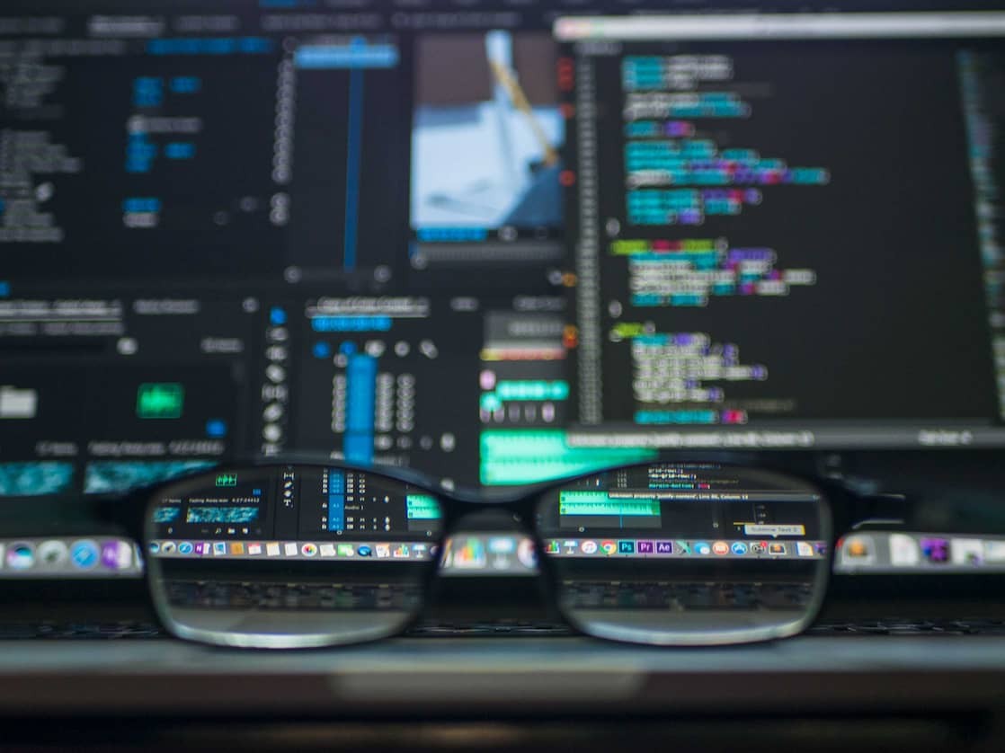 Glasses in front of a blurred computer screen